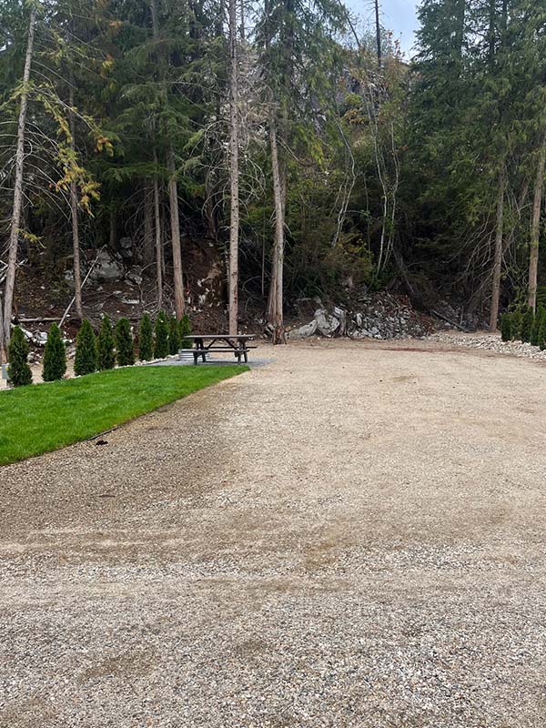 A picture of the picnic table and fire pit in one of our campsites at Mara Lake RV Park & Campground